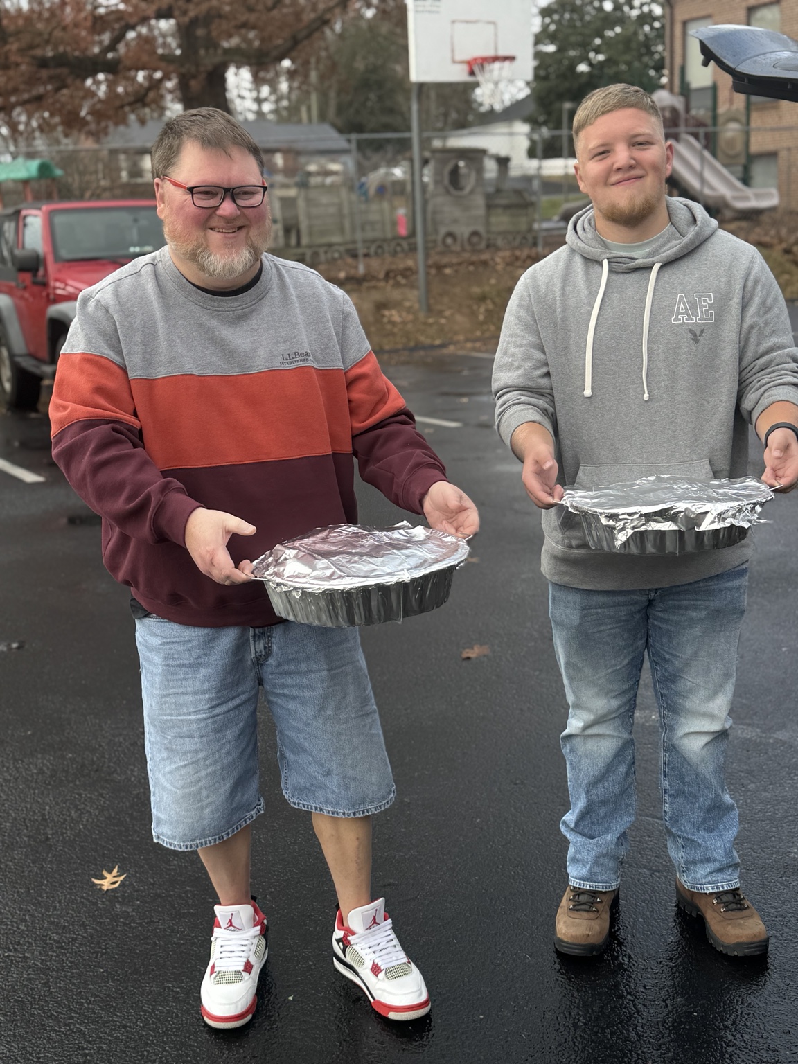 Volunteers carrying prepared Thanksgiving dishes