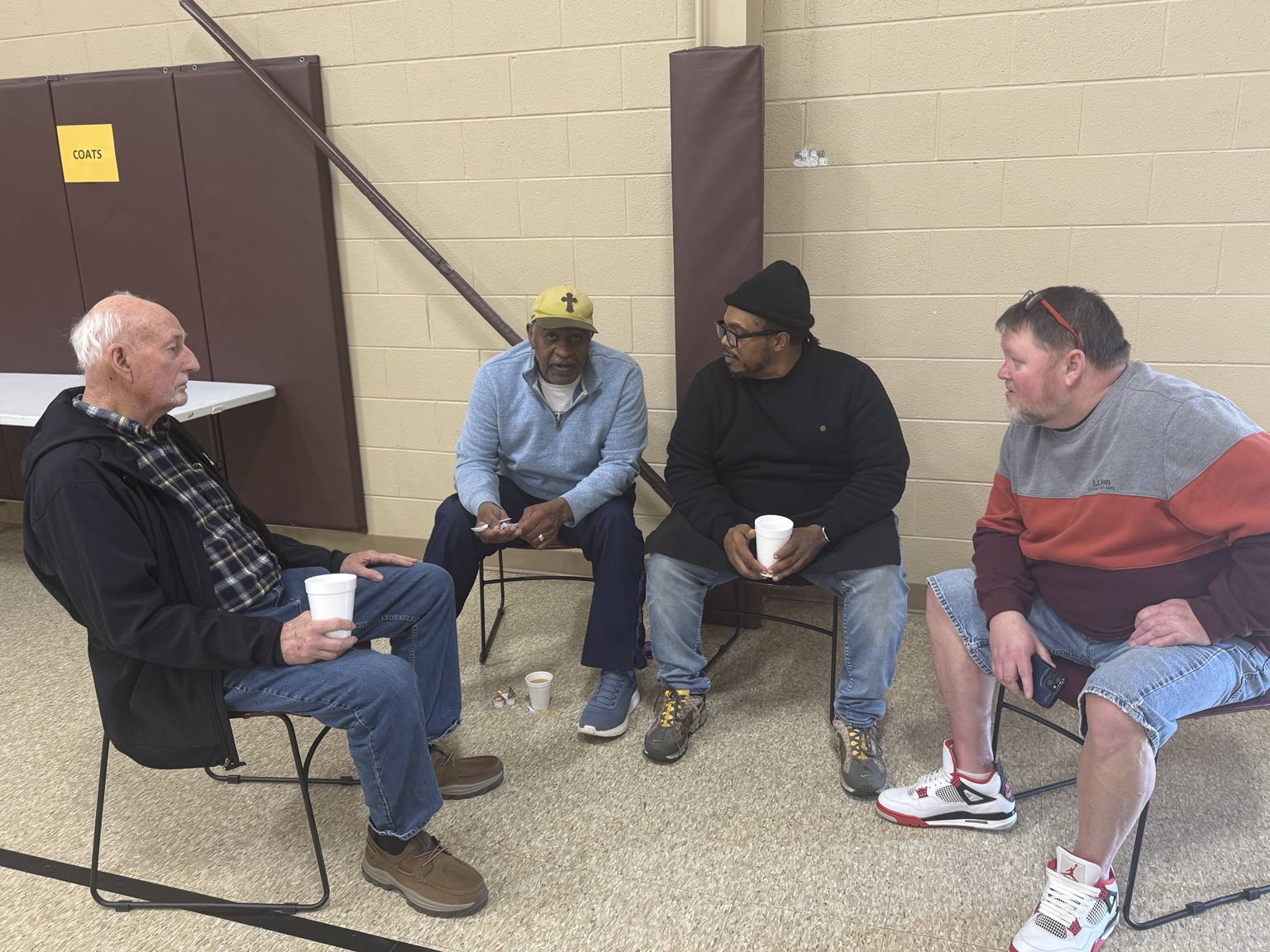 Guests sitting in conversation at Community Thanksgiving