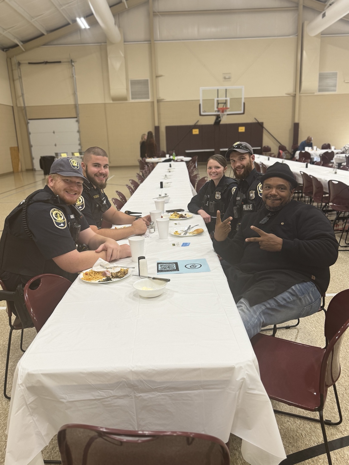Guests and volunteers seated together at a long table