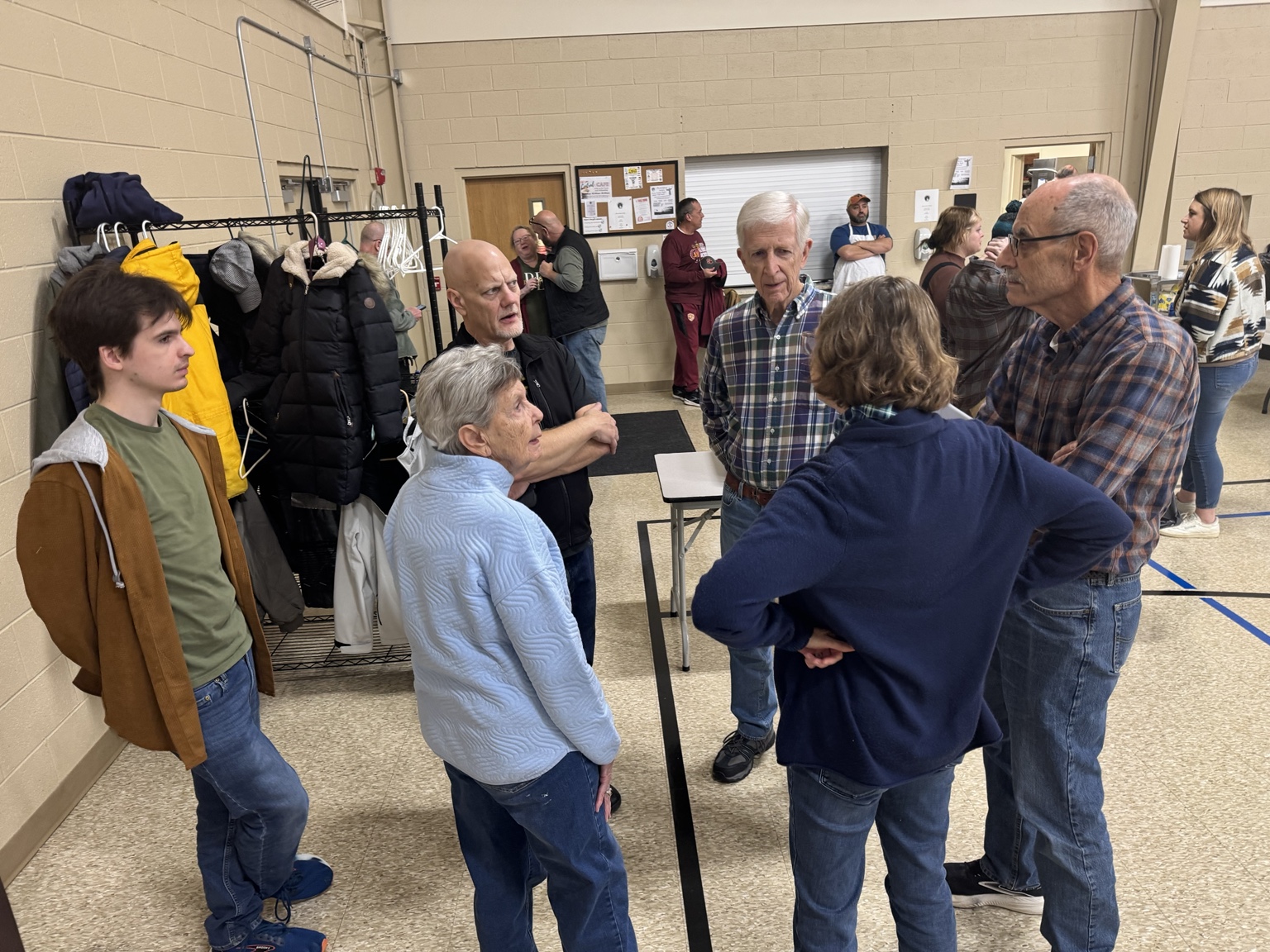 Community members gathering before Thanksgiving dinner