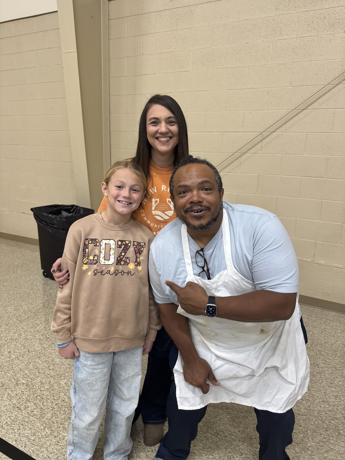 Family smiling together at Community Thanksgiving