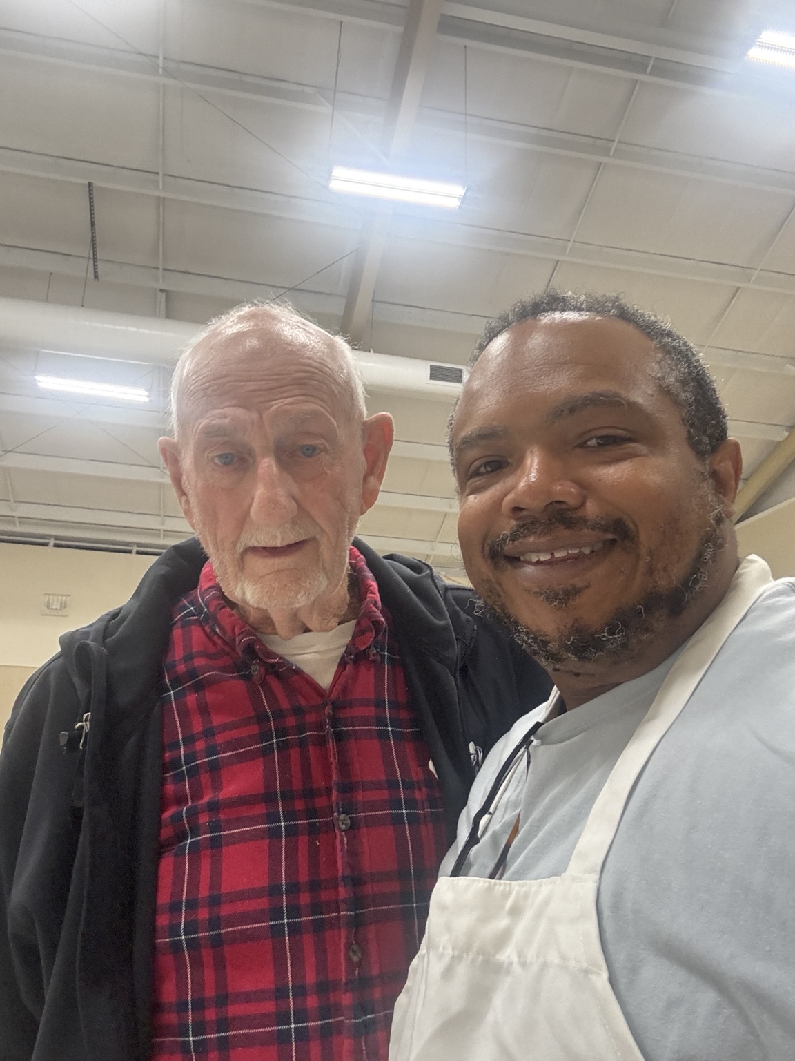 Pastor Brad with a community neighbor at Thanksgiving dinner