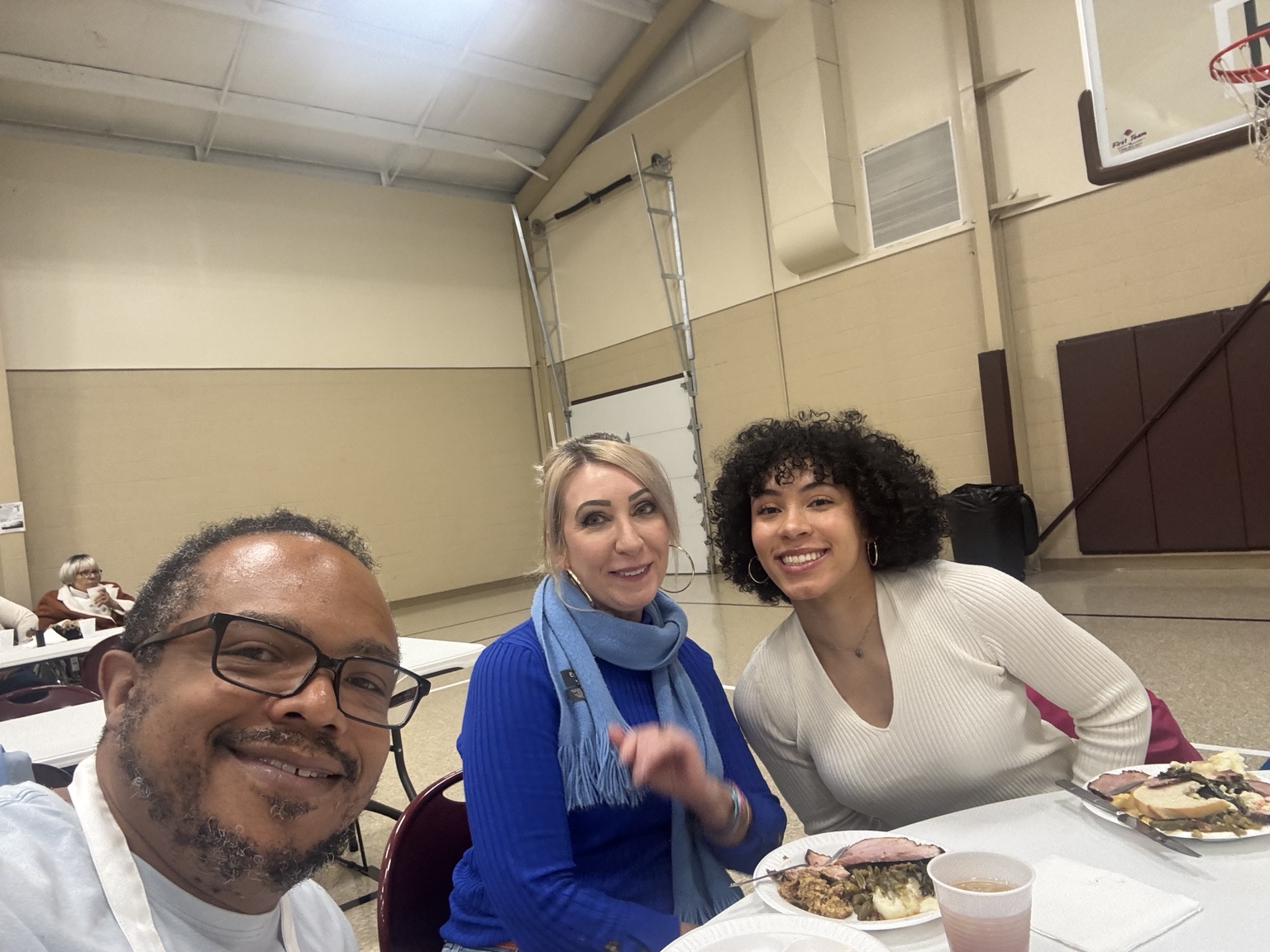 Community Thanksgiving guests seated together at the table