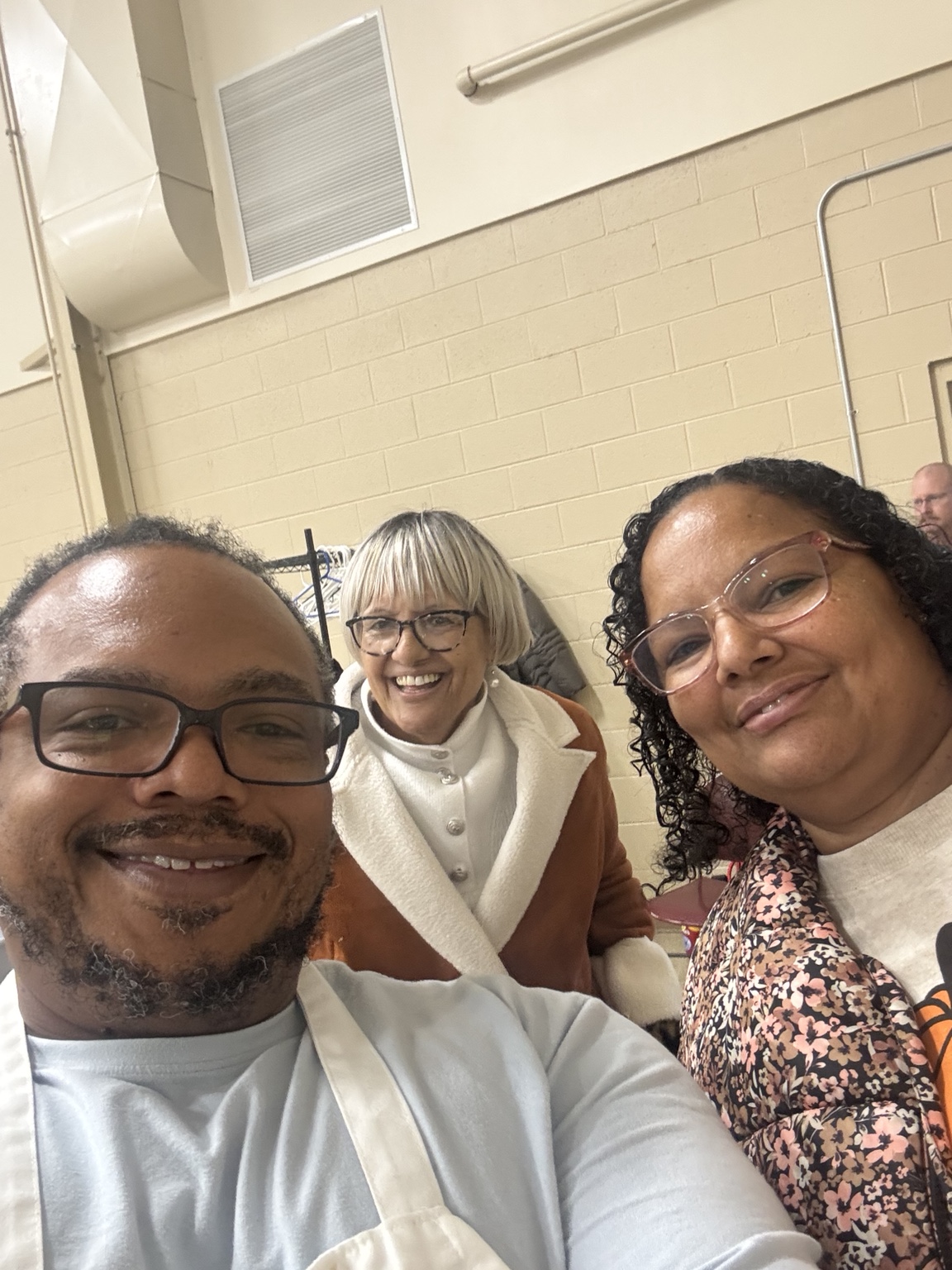 Pastor Brad smiling with community guests at Thanksgiving