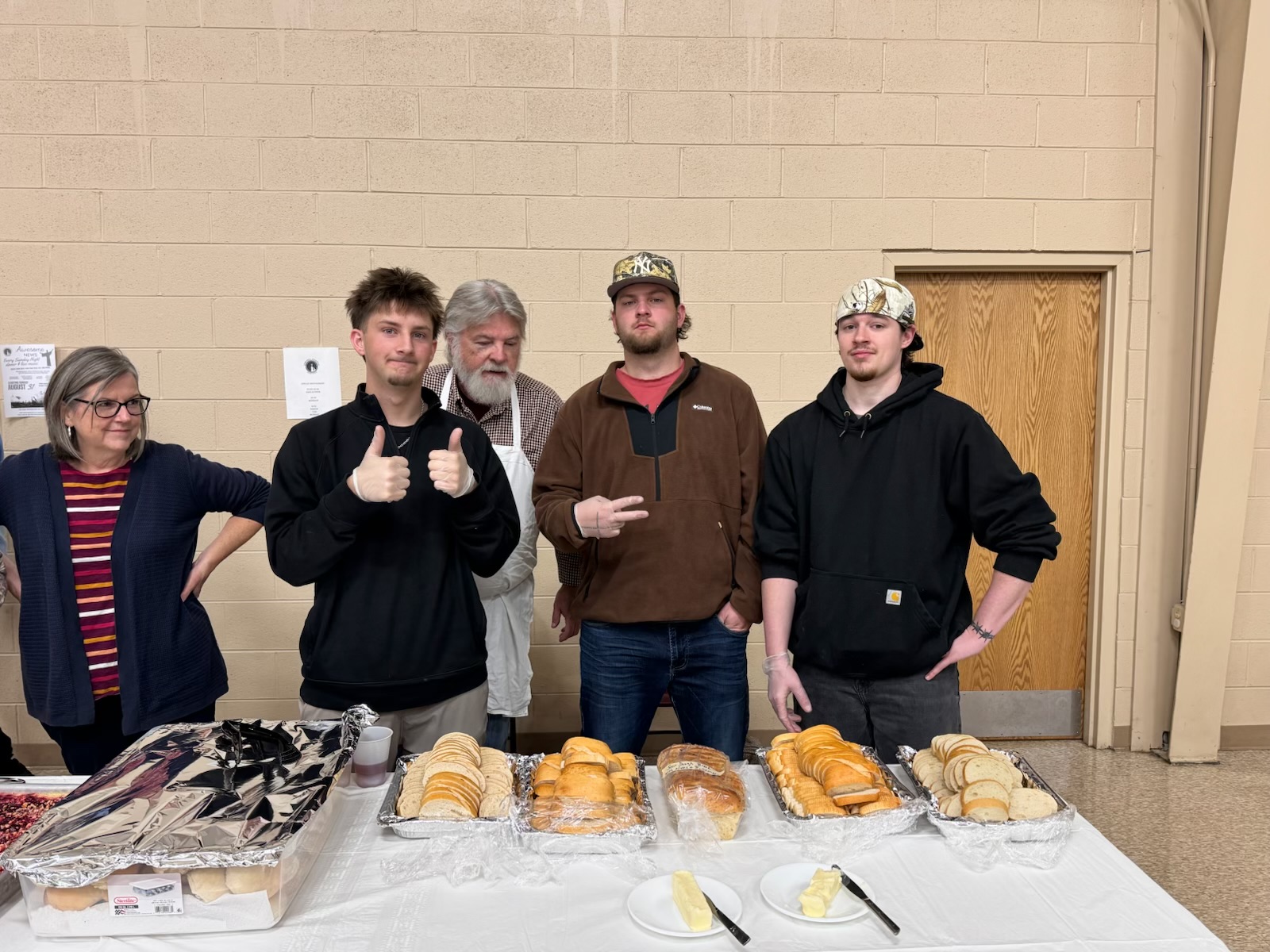 Volunteers standing by prepared desserts